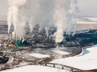 The Suncor Energy upgrading refinery, on the banks of the Athabasca River.     Photo Credit: Copyrighted image; photographer not disclosed.